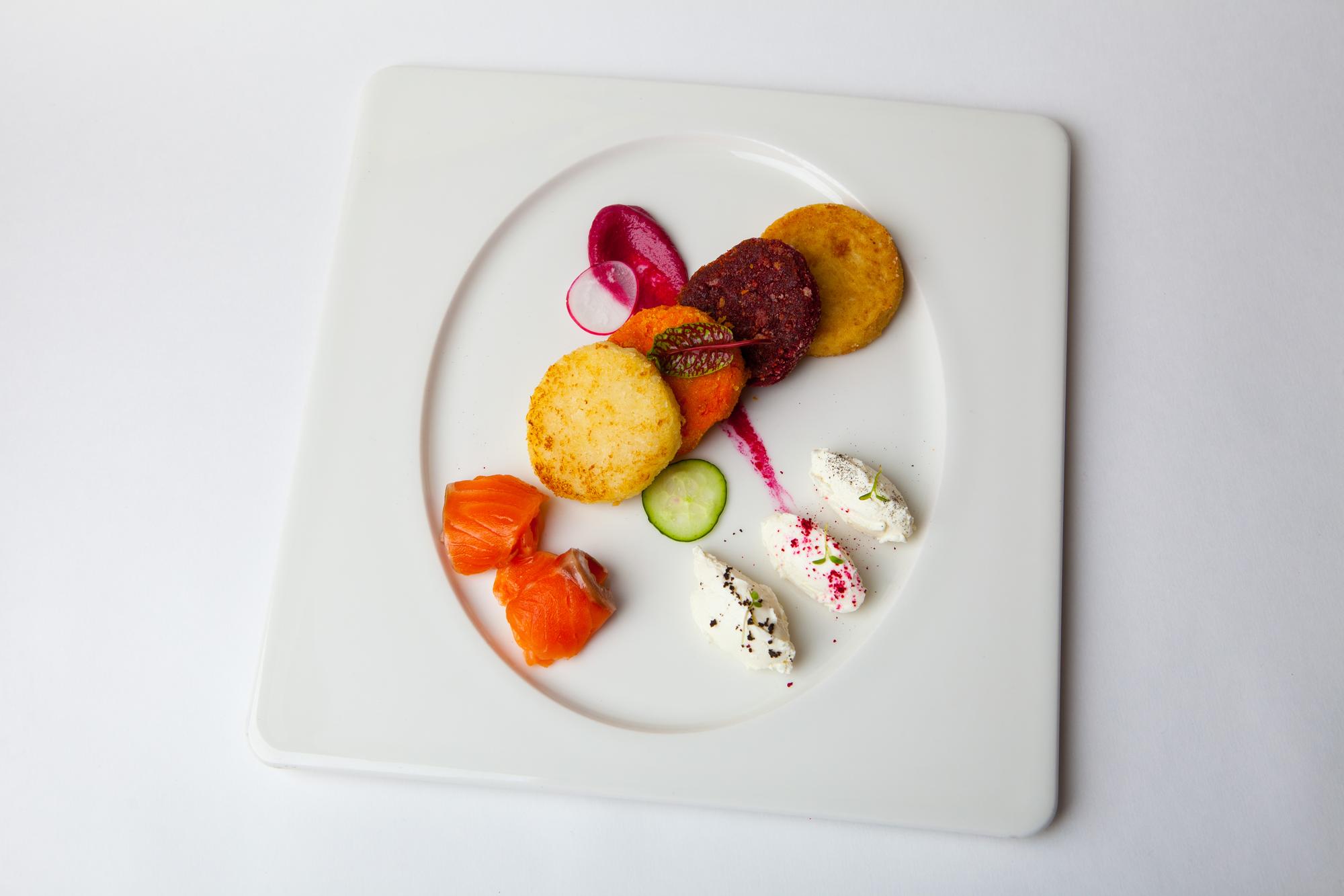 Assorted plated tasting portions on a pastel tray